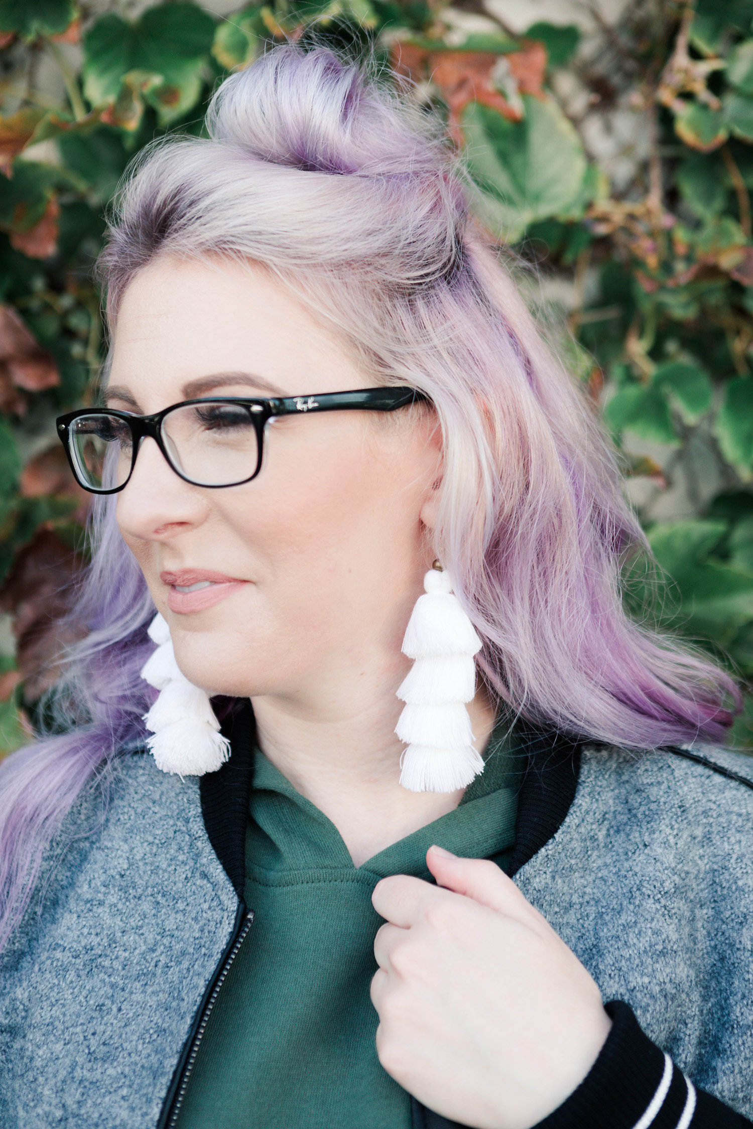 tassel earrings, rayban glasses, top bun hairstyle